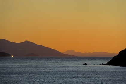 Italie, Toscane, l’Ile d’Elbe au coucher de soleil et la côte à Piombino en premier plan