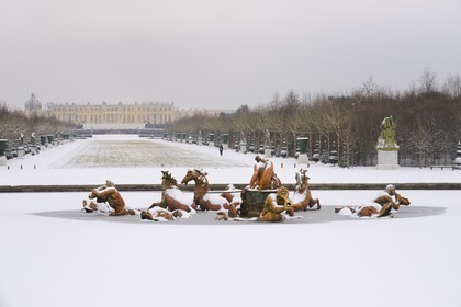 France, Yvelines (78), parc du château de Versailles sous la neige, classé Patrimoine Mondial de l'UNESCO, le bassin d'Apollon par Tuby avec le char d'Apollon et l'axe du Soleil vers le château