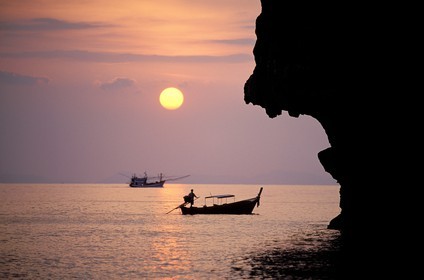 Thaïlande, Archipel de Ko Phi Phi, île de Phi Phi Don, Nui Bay au coucher du soleil, Vertigineuses falaises et bateaux Long Tail