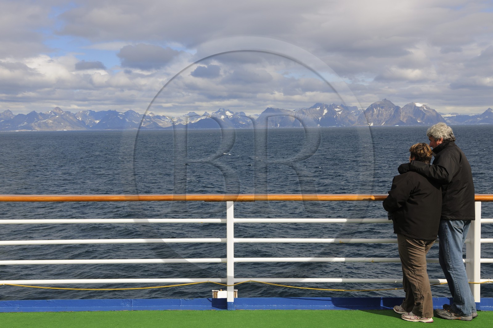 Groenland, région méridionale, couple observant la côte au large du Cap Farvel (Farewell) à bord du bateau de croisière le Princess Danané