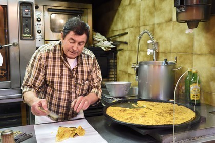 Principauté de Monaco, Monaco, Marché de la Condamine, Roger découpe des parts de socca dans son échoppe