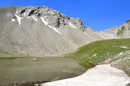 France, Alpes-de-Haute-Provence (04), Uvernet-Fours, parc national du Mercantour, vallée de l'Ubaye, sentier de randonnée du circuit des lacs qui grimpe vers le col de la Petite Cayolle (2639 m) en arrière plan à droite, petit lac et névé