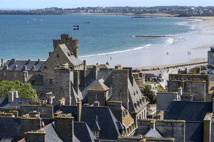 France, Ille-et-Vilaine (35), Côte d'Emeraude, Saint-Malo, les toits de la ville intra-muros, le Grand Donjon sur lequel flotte le drapeau de la ville et la grande Plage du Sillon en arrière plan