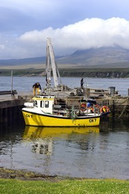 Royaume-Uni, Ecosse, Hébrides intérieures, Ile de Islay, bateau de pêche à Port Askaig et les montagnes de l'île de Jura en arrière plan