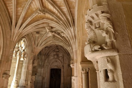 France, Dordogne (24), Périgord Noir, Le Buisson-de-Cadouin, abbaye de Cadouin, étape sur le chemin de Compostelle, site classé Patrimoine Mondial de l'UNESCO, galerie orientale du cloitre du XVe siècle, Lazare le mendiant de la parabole à l'entrée de la salle capitulaire à droite et la Porte Royale en arrière plan